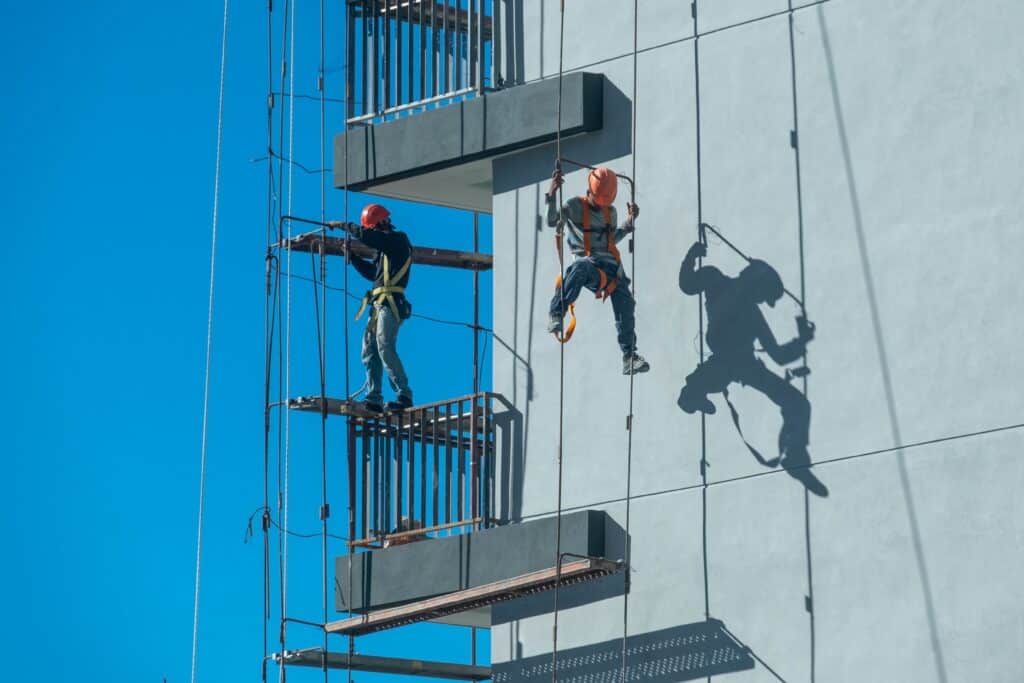 Couple Workers Fixing Scaffolding