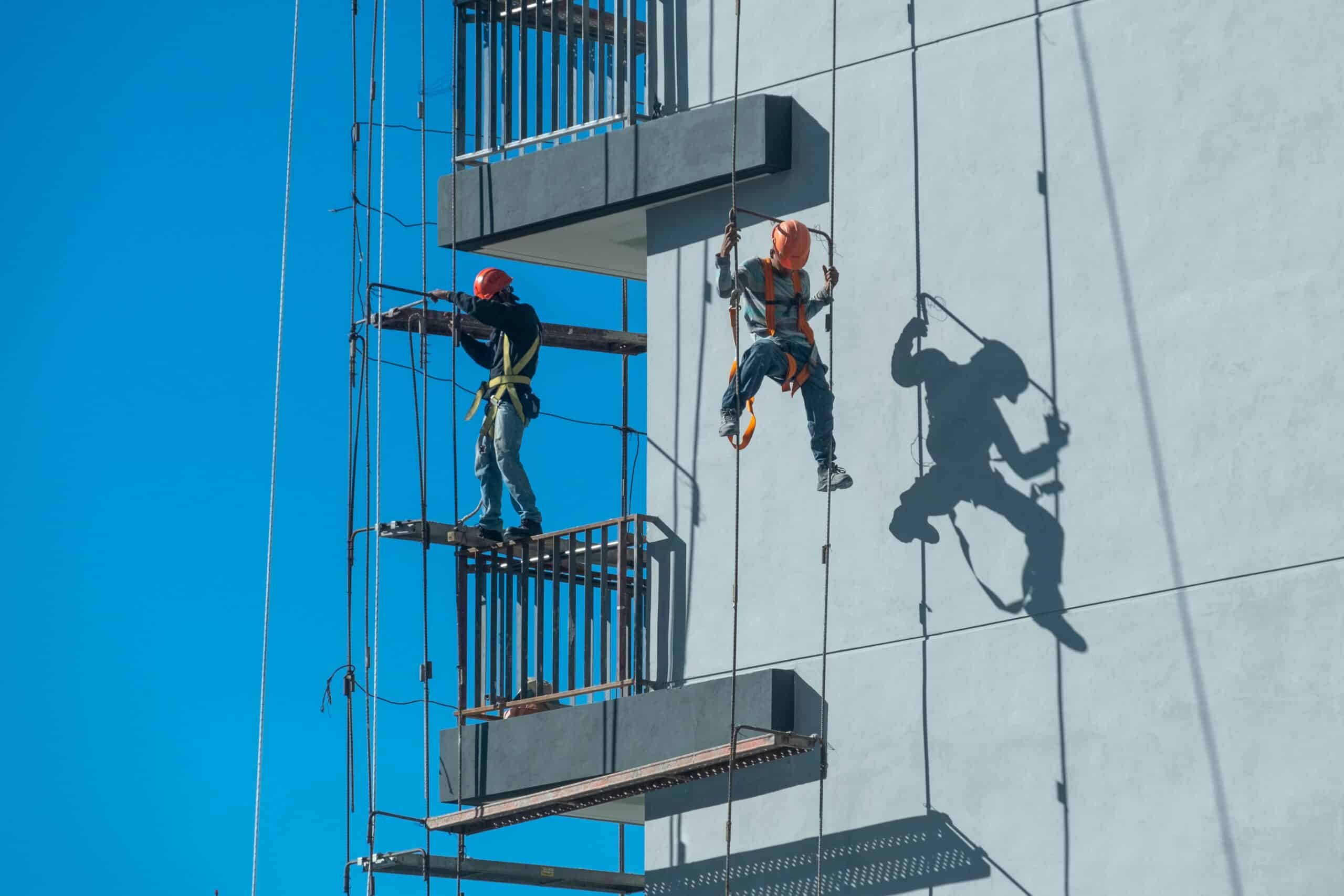 Couple Workers Fixing Scaffolding